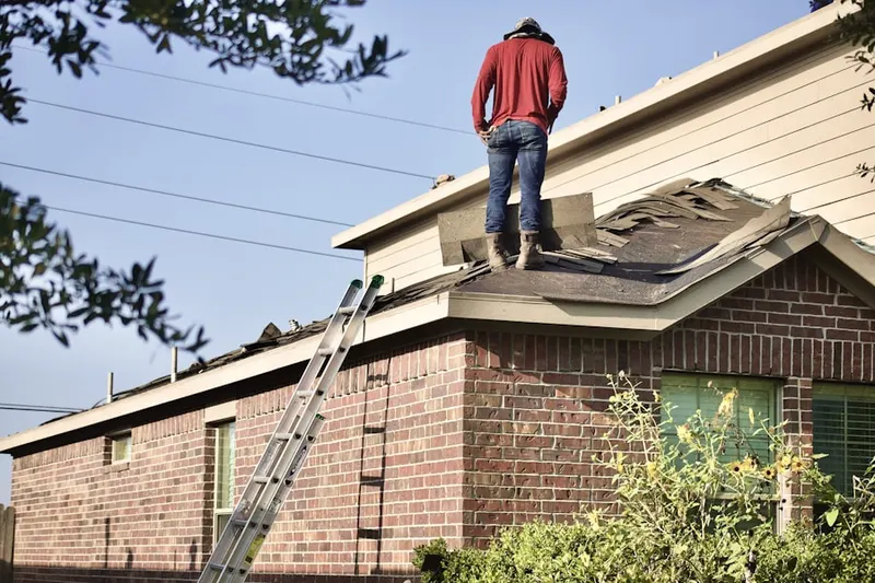 Professional roofer working on a residential roof in Bridgestone West